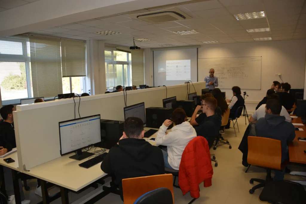 Students attending a computer lab lecture with instructor presenting