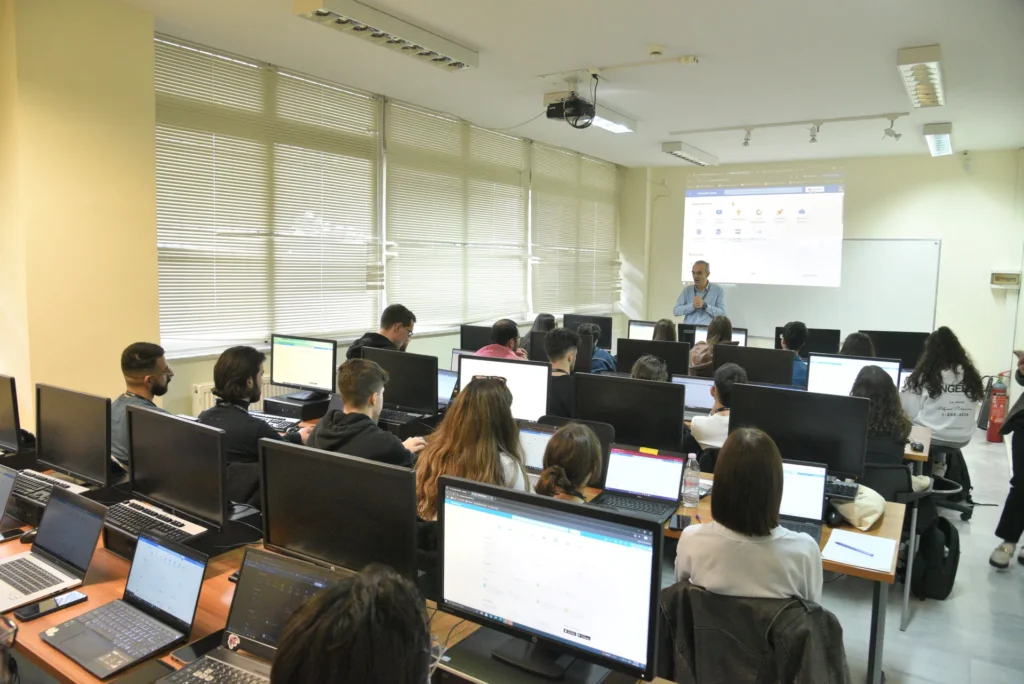 Students in a computer lab attending a classroom lecture